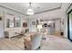 Open-concept living room featuring an adjacent kitchen, neutral tones, and bright natural light at 13303 Swiftwater Way, Lakewood Ranch, FL 34211