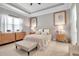 Bright main bedroom features tray ceiling, accent furniture, and neutral tones at 13303 Swiftwater Way, Lakewood Ranch, FL 34211