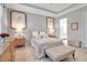 Serene main bedroom with soft colors, wood floors, and ensuite bathroom access at 13303 Swiftwater Way, Lakewood Ranch, FL 34211