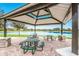 Shaded picnic area featuring tables and seating with a tranquil lake backdrop at 13303 Swiftwater Way, Lakewood Ranch, FL 34211