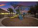 Community playground with modern equipment set against a sunset, creating a safe and fun environment for children at 13303 Swiftwater Way, Lakewood Ranch, FL 34211