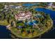 Beautiful aerial view of the community clubhouse showcasing the pools, tennis courts, and stunning architecture at 16416 Baycross Dr, Lakewood Ranch, FL 34202