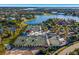 Aerial view of tennis courts nestled in a picturesque community with lakes, lush landscapes, and beautiful homes at 16416 Baycross Dr, Lakewood Ranch, FL 34202