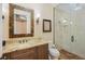 Bathroom featuring a granite vanity countertop, and travertine shower with glass door at 16416 Baycross Dr, Lakewood Ranch, FL 34202