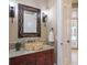 Bathroom with granite countertops, unique rock sink, and ornate mirror at 16416 Baycross Dr, Lakewood Ranch, FL 34202