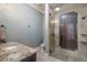 Bathroom featuring tiled shower with glass door, granite countertops, and modern fixtures at 16416 Baycross Dr, Lakewood Ranch, FL 34202