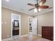 Neutral bedroom with hardwood floors, ceiling fan, tan walls, and attached bathroom at 16416 Baycross Dr, Lakewood Ranch, FL 34202