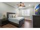 Bedroom with dark hardwood floors, soft blue walls, and shuttered windows at 16416 Baycross Dr, Lakewood Ranch, FL 34202