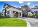 Grand entrance to the clubhouse with stone accents, lush landscaping, and covered parking at 16416 Baycross Dr, Lakewood Ranch, FL 34202