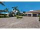 Wide brick driveway leading to a gated estate with a three-car garage at 16416 Baycross Dr, Lakewood Ranch, FL 34202