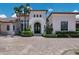 Close up of the arched entryway with a grand entrance and manicured landscaping at 16416 Baycross Dr, Lakewood Ranch, FL 34202