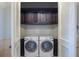 Laundry room features a washer, dryer, and dark wood cabinets at 16416 Baycross Dr, Lakewood Ranch, FL 34202