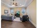 Relaxing living room featuring tray ceilings, hardwood floors, and comfortable seating arrangement at 16416 Baycross Dr, Lakewood Ranch, FL 34202