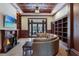 Living room features built-in shelving, coffered ceiling, fireplace, and media center at 16416 Baycross Dr, Lakewood Ranch, FL 34202