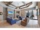 Inviting living room with wood beam ceiling, a stone fireplace, and access to the outdoor living area at 16416 Baycross Dr, Lakewood Ranch, FL 34202