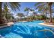 Resort-style pool surrounded by palm trees and lounge chairs, offering a perfect spot for relaxation and recreation at 16416 Baycross Dr, Lakewood Ranch, FL 34202