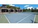 Outdoor tennis court with a covered viewing area is perfect for sports enthusiasts and social gatherings at 16416 Baycross Dr, Lakewood Ranch, FL 34202