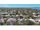 Wide aerial perspective of a residential area interspersed with trees and glimpses of the surrounding landscape at 1687 Arlington St, Sarasota, FL 34239