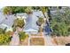 Bird's eye view of a well-kept residence with a metal roof, driveway, and a mix of trees at 1687 Arlington St, Sarasota, FL 34239