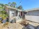 Backyard nook with bench seating and shaded awning, perfect for relaxation and outdoor enjoyment at 1687 Arlington St, Sarasota, FL 34239