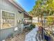 Landscaped yard with paver walkway leading to a screened porch and metal fence at 1687 Arlington St, Sarasota, FL 34239