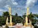 Elaborate archway with palm trees marking the entrance to Sarasota Bayfront, Florida, on a sunny day at 1687 Arlington St, Sarasota, FL 34239