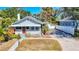 Charming cottage-style home boasts a bright red front door, gray siding, and a well-maintained front yard at 1687 Arlington St, Sarasota, FL 34239