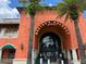 Exterior view of Morton's Gourmet Market featuring terracotta exterior, grand arched entrance, and well-kept landscaping at 1687 Arlington St, Sarasota, FL 34239