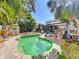 A relaxing pool is surrounded by landscaping, a patio and pergola at 1687 Arlington St, Sarasota, FL 34239