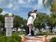 Statue of the Unconditional Surrender sculpture in Sarasota, Florida, with boats in the background on a partly sunny day at 1687 Arlington St, Sarasota, FL 34239