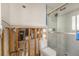 Bright bathroom featuring a modern glass shower, a toilet and a large window at 1719 New Hampshire Ne Ave, St Petersburg, FL 33703