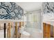 Bright bathroom featuring a shower over tub, modern fixtures and patterned wallpaper at 1719 New Hampshire Ne Ave, St Petersburg, FL 33703