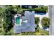 Aerial view of home showcasing pool, patio, and lush landscaping at 1735 Flower Dr, Sarasota, FL 34239