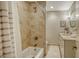 Bright bathroom features a bathtub with tiled walls and a vanity with decorative mirror at 1735 Flower Dr, Sarasota, FL 34239