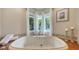 Bright bathroom with a large tub under a bay window, offering privacy and natural light at 1735 Flower Dr, Sarasota, FL 34239