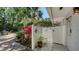 Secluded outdoor shower features colorful accents and lush tropical plants at 1735 Flower Dr, Sarasota, FL 34239