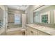 Bathroom with tub and shower, white vanity with marble countertop, and tile backsplash at 1919 Irving St, Sarasota, FL 34236