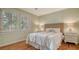 Comfortable bedroom showcases hardwood floors, decorative touches and natural light from windows with shutters at 1919 Irving St, Sarasota, FL 34236