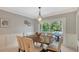 Dining room with modern lighting fixture and a sliding glass door view of the pool and backyard at 1919 Irving St, Sarasota, FL 34236