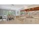 Bright kitchen with marble countertops, white cabinets, and an adjacent dining area with large windows at 1919 Irving St, Sarasota, FL 34236