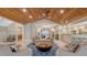 Bright living room featuring a vaulted wood ceiling, tile floors, and elegant furniture arrangements at 1919 Irving St, Sarasota, FL 34236