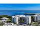 Coastal condo building featuring manicured grounds and stunning views of the bay at 1932 Harbourside Dr # 244, Longboat Key, FL 34228