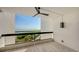 Balcony with tile floors and a glass railing offering scenic views of the water and natural surroundings at 1932 Harbourside Dr # 244, Longboat Key, FL 34228