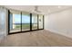 Bedroom featuring wood floors, ceiling fan and a sliding glass door leading to a balcony with a view at 1932 Harbourside Dr # 244, Longboat Key, FL 34228