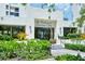 View of the clubhouse entrance with manicured landscaping at Fairway Bay at 1932 Harbourside Dr # 244, Longboat Key, FL 34228