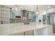 Modern kitchen featuring a large island, updated appliances, and decorative lighting at 1932 Harbourside Dr # 244, Longboat Key, FL 34228