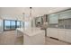 Modern kitchen with a view and a large island with pendant lights at 1932 Harbourside Dr # 244, Longboat Key, FL 34228