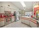 Well-lit kitchen featuring stainless steel appliances, white cabinets, and a skylight at 19484 Midway Blvd, Port Charlotte, FL 33948