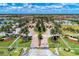 Aerial view of the gated community entrance with lush landscaping and palm tree-lined streets at 20170 Benissimo Dr, Venice, FL 34293