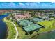 Community aerial view showcasing multiple tennis courts, lush landscaping, and beautiful surrounding neighborhood at 20170 Benissimo Dr, Venice, FL 34293